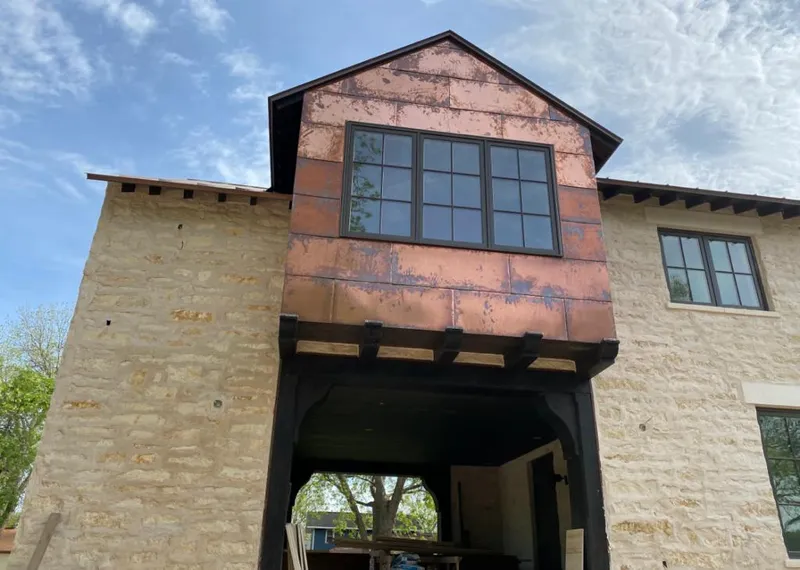 Copper metal panel facade on a stone building for Roof Repair in Mesa